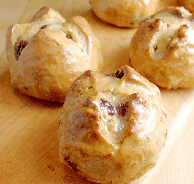 hot cross buns on a wood surface