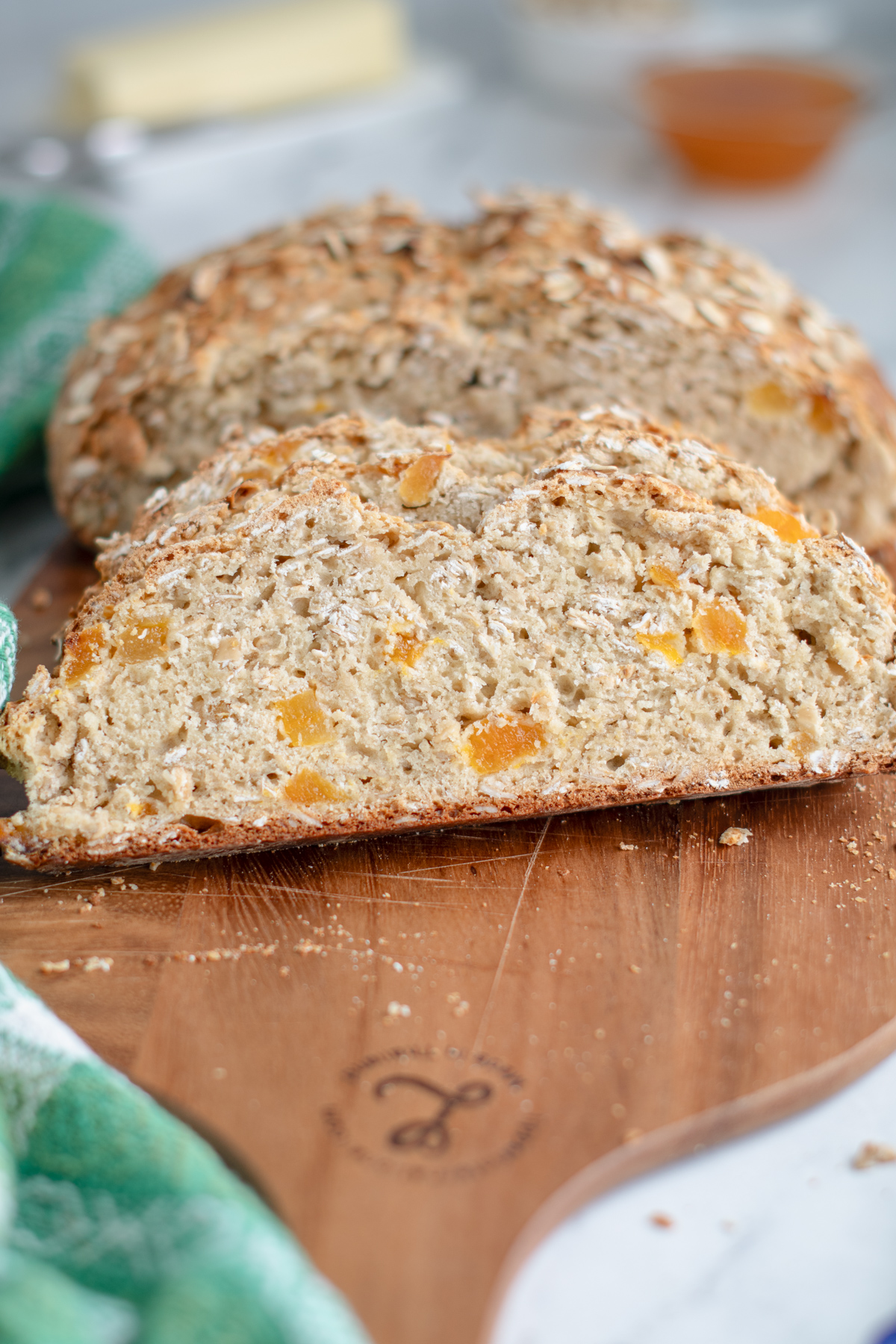 a sliced loaf of oatmeal soda bread on a cutting board. 