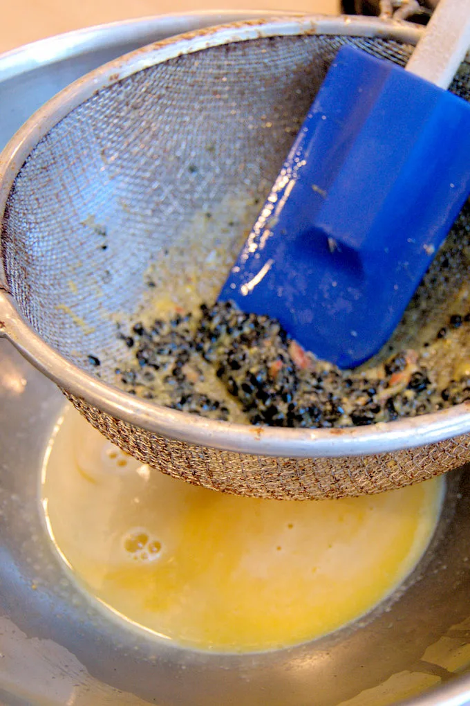 Straining passion fruit juice to remove seeds