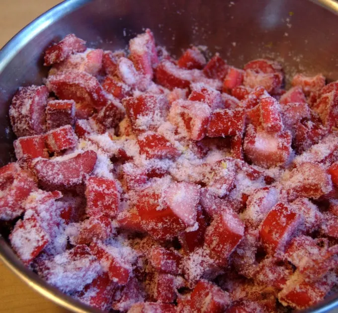 a bowl of chopped rhubarb with sugar