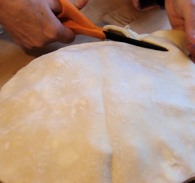 I have a pair of kitchen scissors that I use the trim the dough. Keep the scraps for pie scrap cookies.