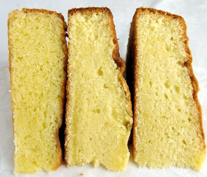 Three slices of vanilla cake side by side on a white background.