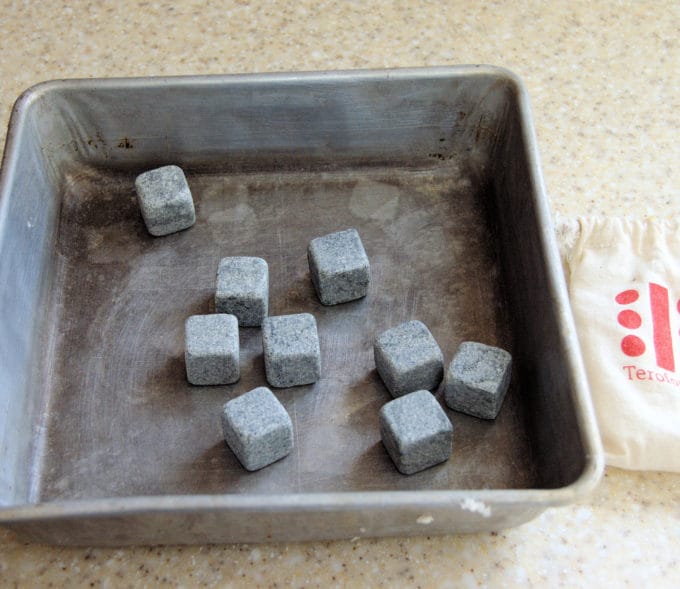 I place a small pan with "whiskey rocks" onto the floor of the oven. Pour water over the preheated rocks to create steam.