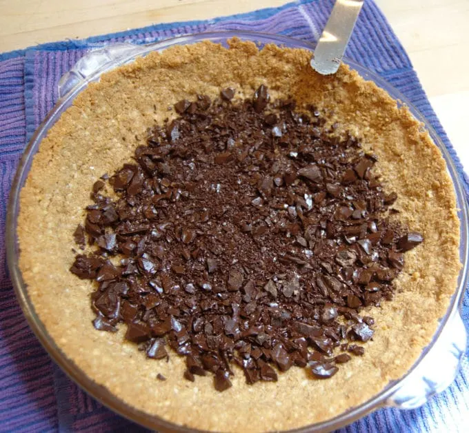 Chopped chocolate on a graham cracker crust.