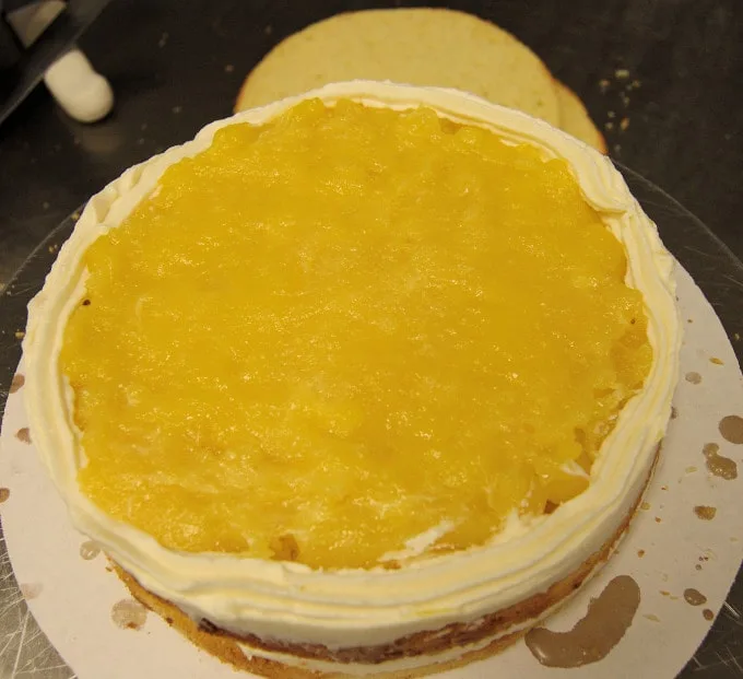 a layer of passion fruit curd on a cake