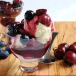 a bowl of Cheesecake Ice Cream with blueberry and cherry compote