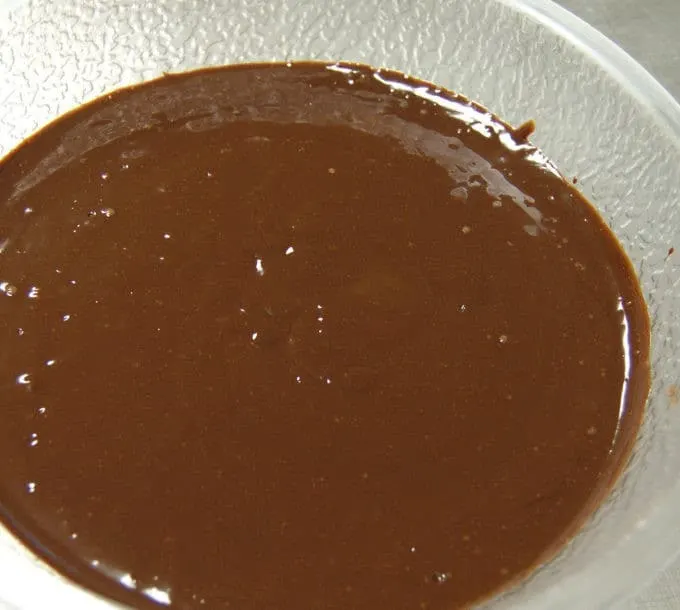Allow the ganache to settle for a minute and then tap the bowl on the work surface to expel some of the bubbles.