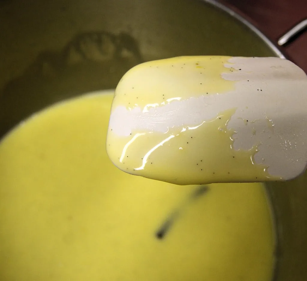 A spatula coated with custard.