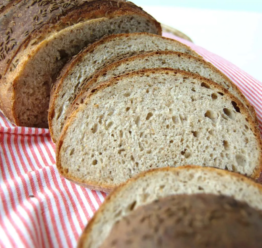 a slice loaf of rye bread in a basket