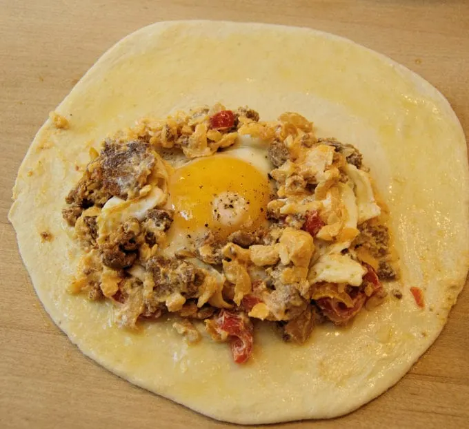 a breakfast calzone with an egg