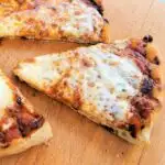 a slice of pizza on a cutting board