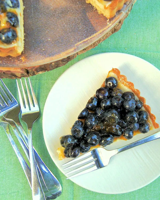 a slice of blueberry cheesecake tart on a plate