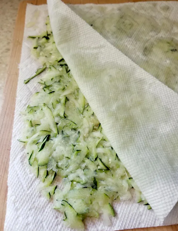 shredded zucchini layered between paper towels