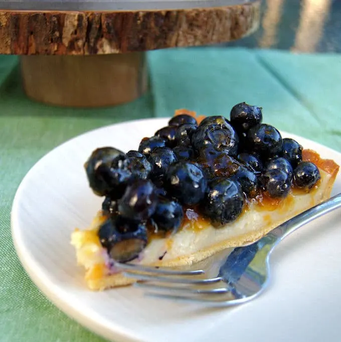 a slice of blueberry cheesecake tart