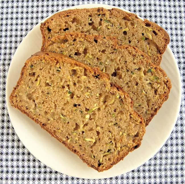 three slices of whole wheat zucchini bread on a plate