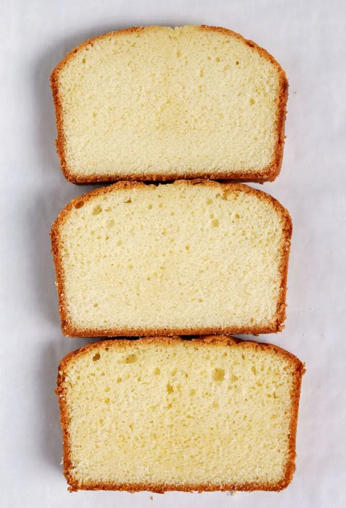 Three slices of pound cake arranged on a white background. Each cake has a different texture.