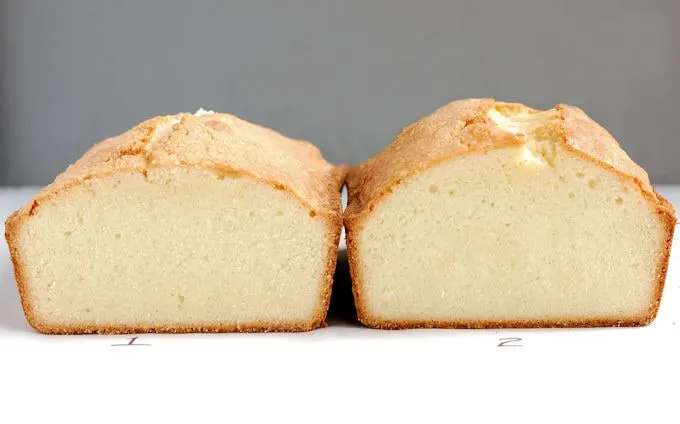 Two pound cakes on a white surface with a gray background
