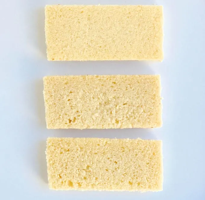 Three slices of yellow cake on a white background