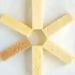 Six different slices of pound cake arranged in a pinwheel pattern on a white surface