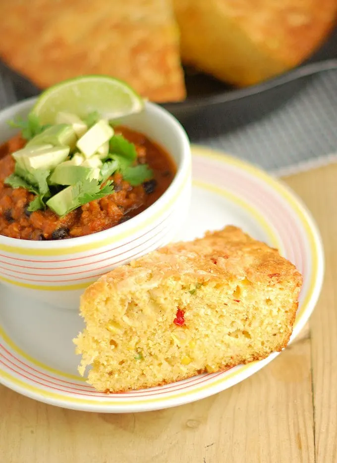 a slice of skillet cornbread and a bowl of chili