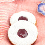 linzer cookies on a pink cloth.