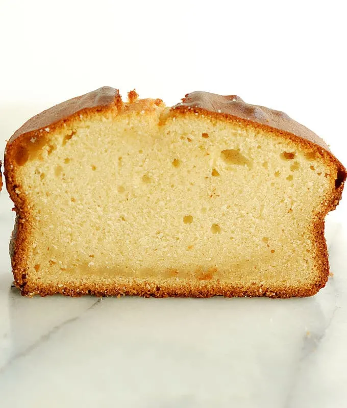 A honey pound cake on a marble slab.