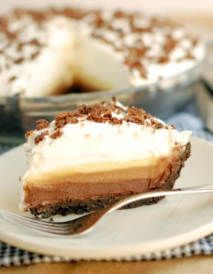 a slice of triple chocolate cream pie on a plate