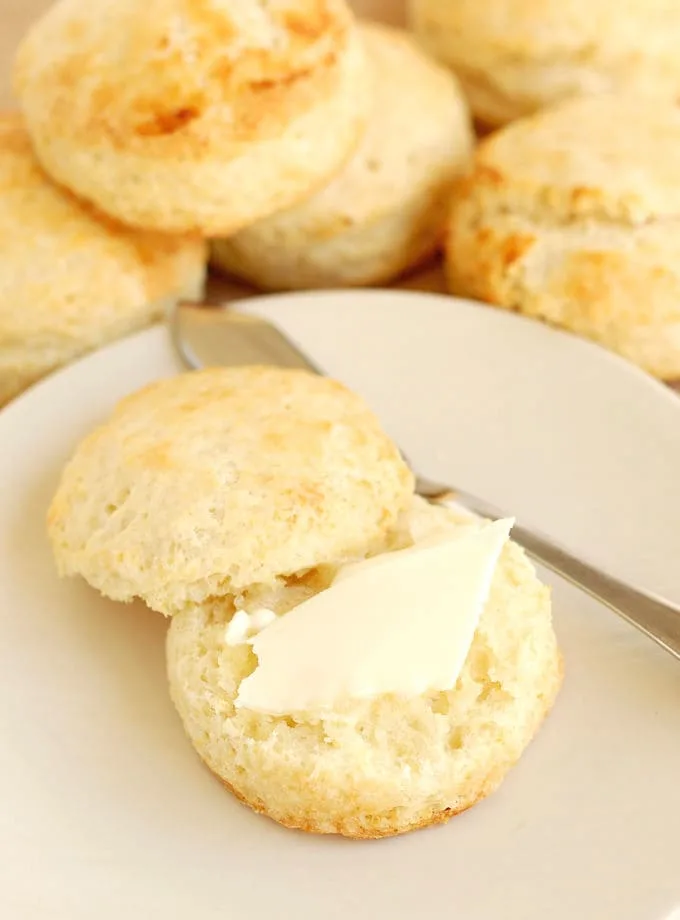 buttermilk biscuit on a plate with a pat of butter