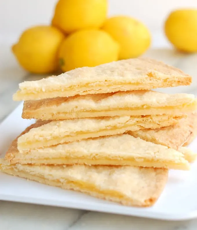 a stack of shortbread cookies filled lemon curd