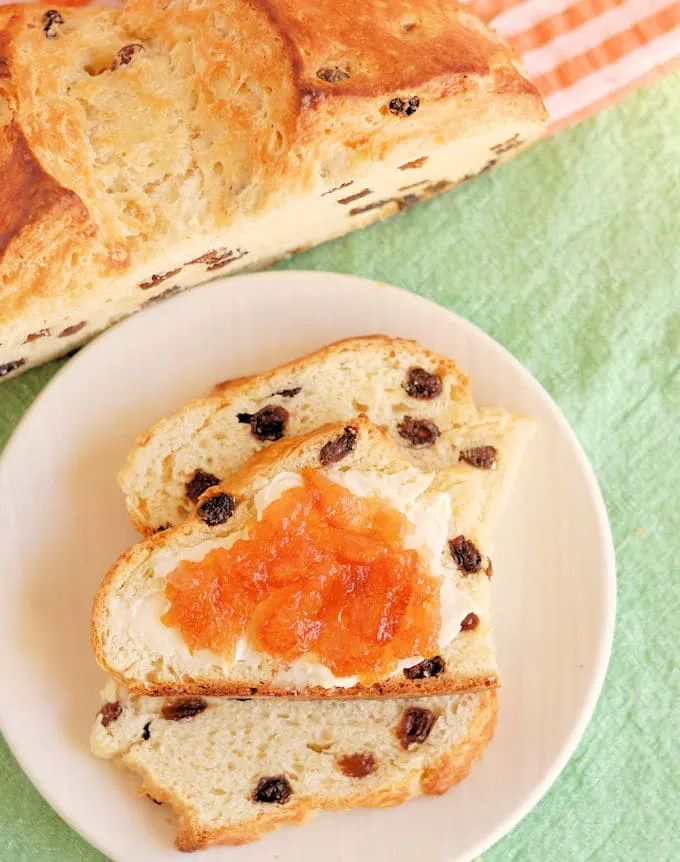 slices of irish soda bread with butter and orange marmalade on a white plate