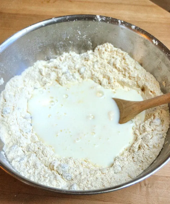 Pour buttermilk into flour to make irish soda bread