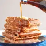 a plate of waffles with syrup