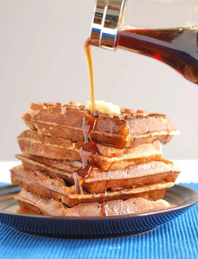 a plate of waffles with syrup