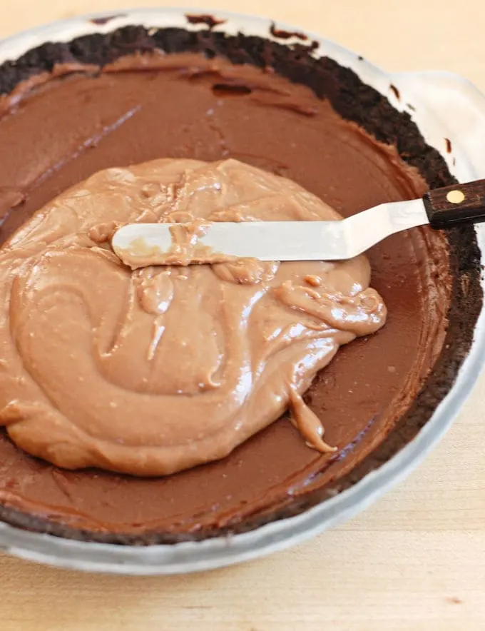 milk chocolate cream being layered over dark chocolate cream