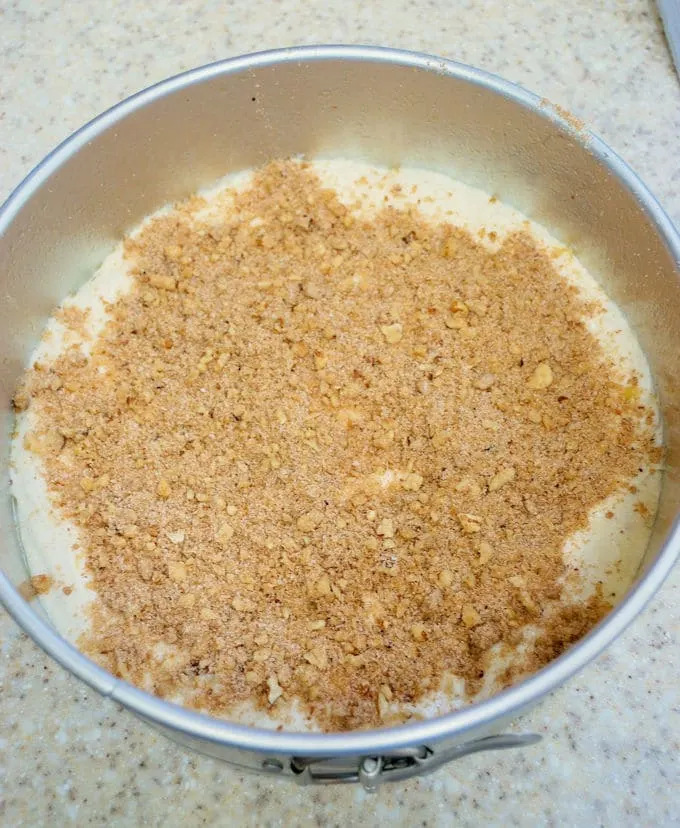 walnut streusel sprinkled onto banana coffee cake batter