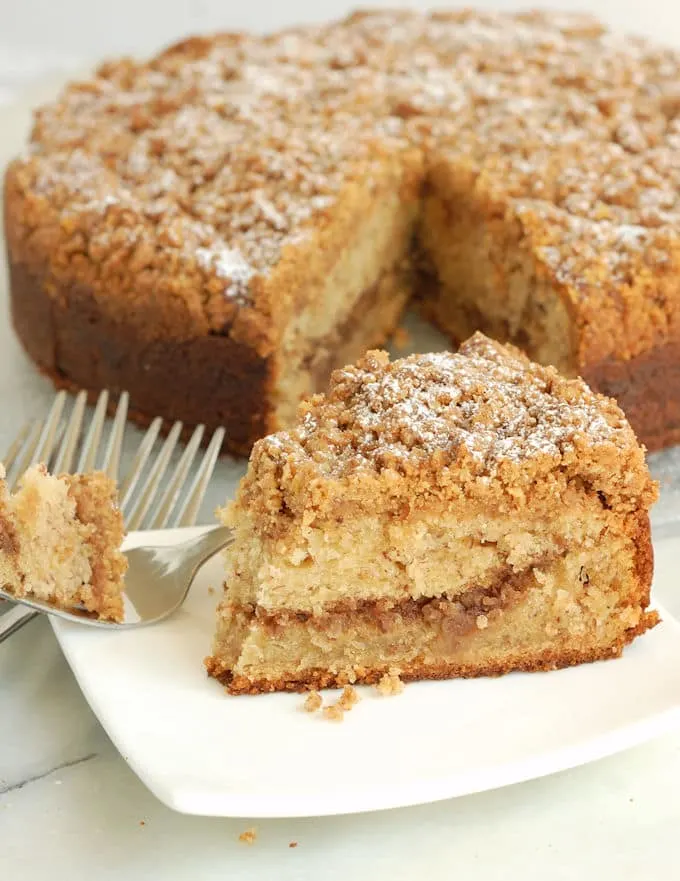 banana coffeecake on a white plate with a fork