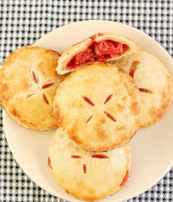 a plate of hand pies filled with roasted strawberries