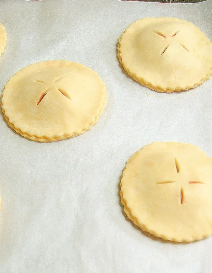 unbaked strawberry hand pies on a tray