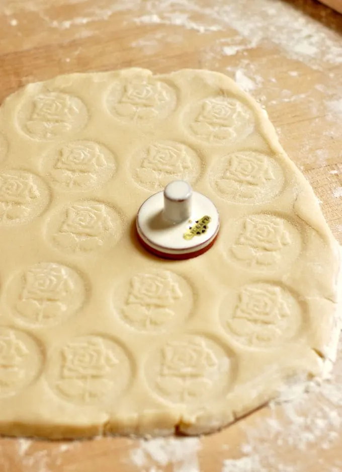 stamping shortbread dough with a cookie stamp