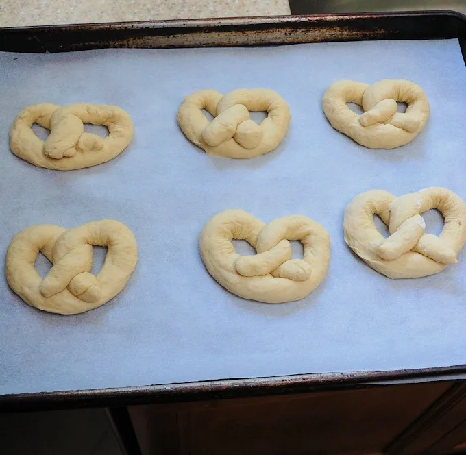 a tray of soft pretzels ready to rise