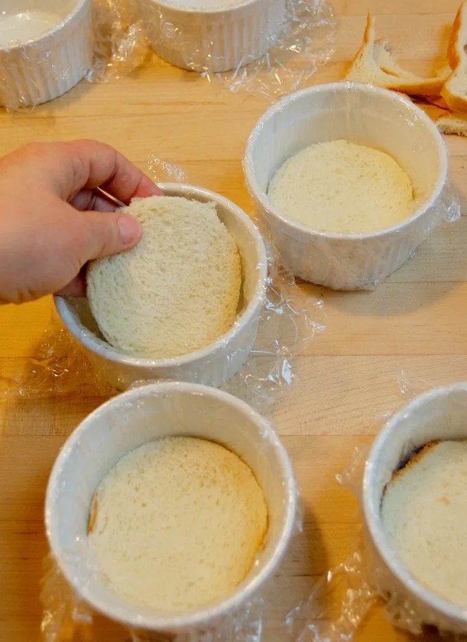 lining ramekins with bread for summer pudding