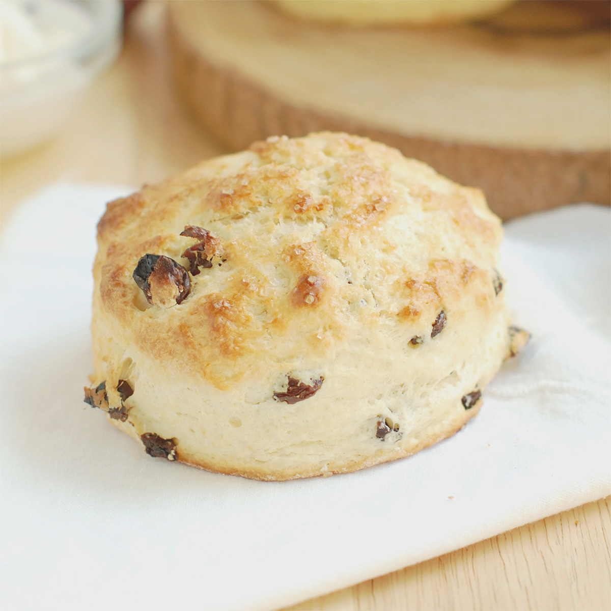 a raisin scone on a cloth napkin.