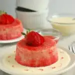 a rhubarb summer pudding with vanilla sauce on a plate