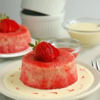 a rhubarb summer pudding with vanilla sauce on a plate
