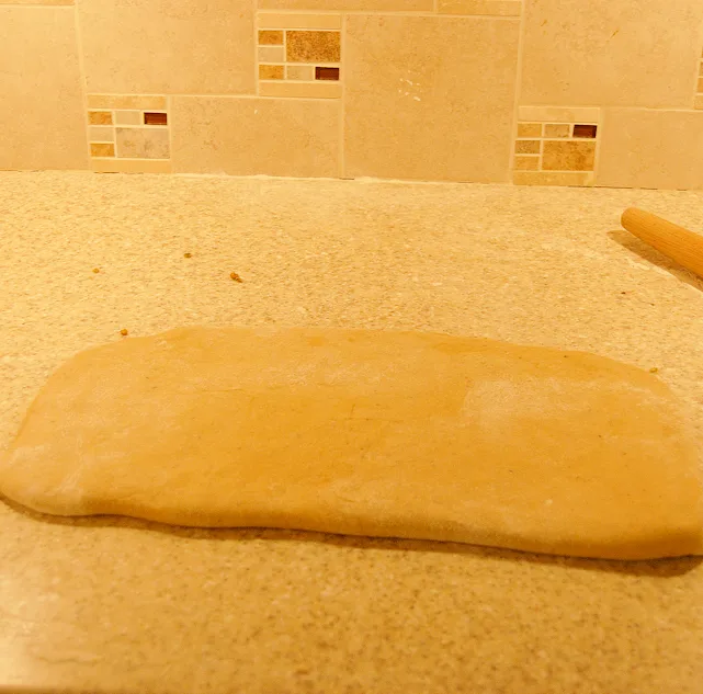 a rectangle of dough folded over pistachio filling