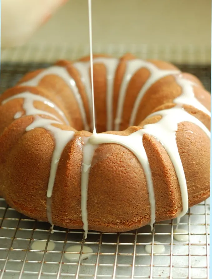 buttermilk bundt cake with buttermilk glaze on a cooling rack