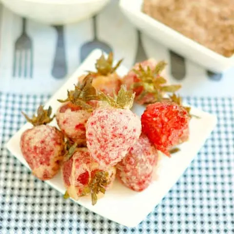 a plate of tempura strawberries