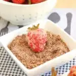 tempura strawberries with dipping sugar in a white bowl