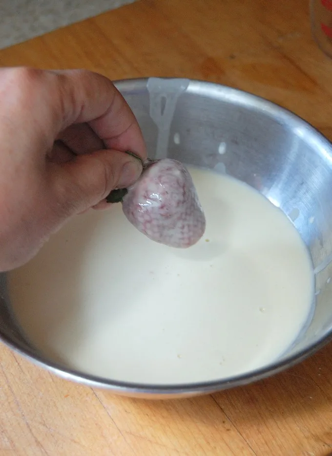 a strawberry dipped in batter