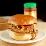 s chicken satay burger with peanut sauce on a plate